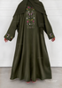 A khaki green abaya dress with a matching headscarf, featuring colorful floral embroidery on the chest and cuffs, shown on a model against a white paneled wall.
