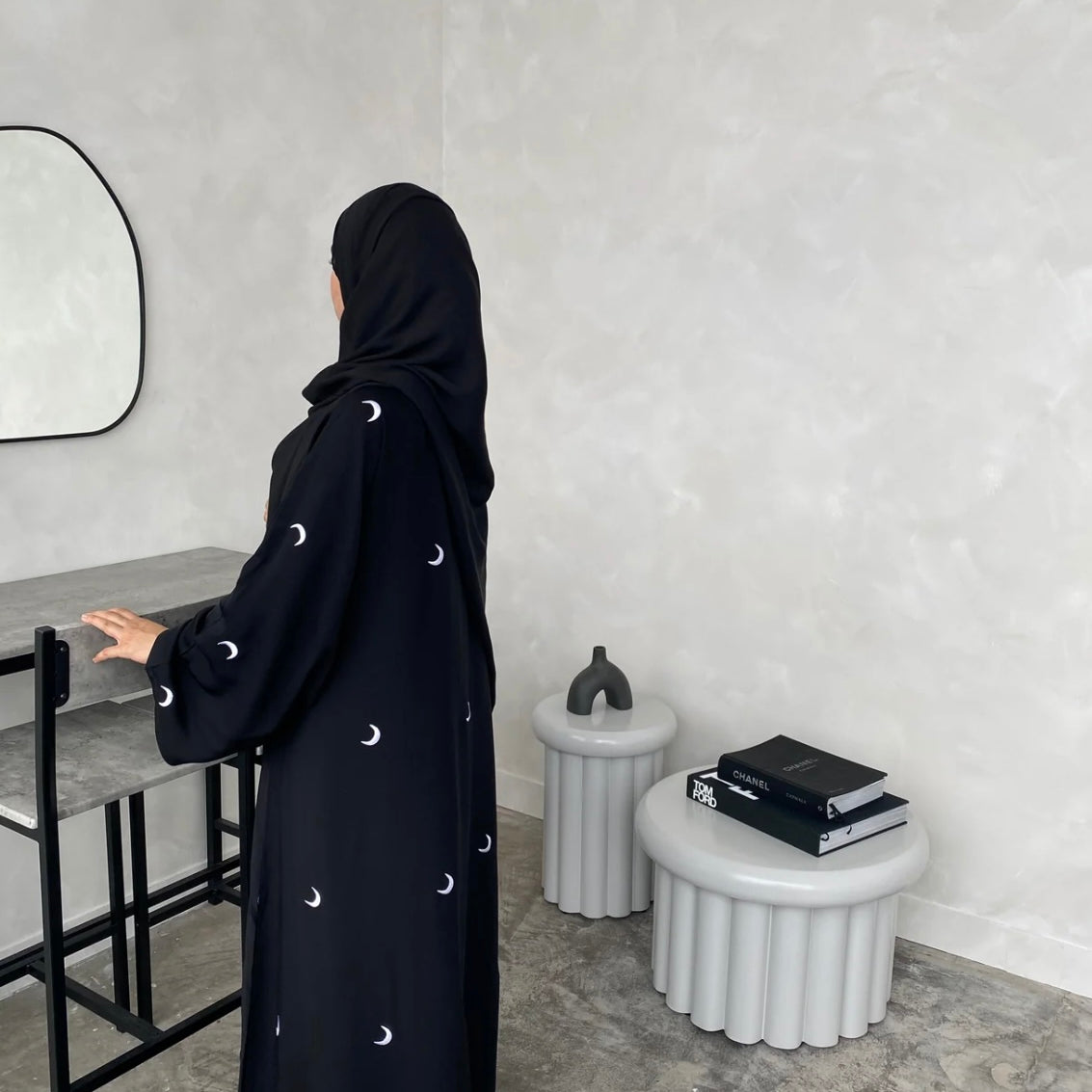 A black abaya with moon patterns