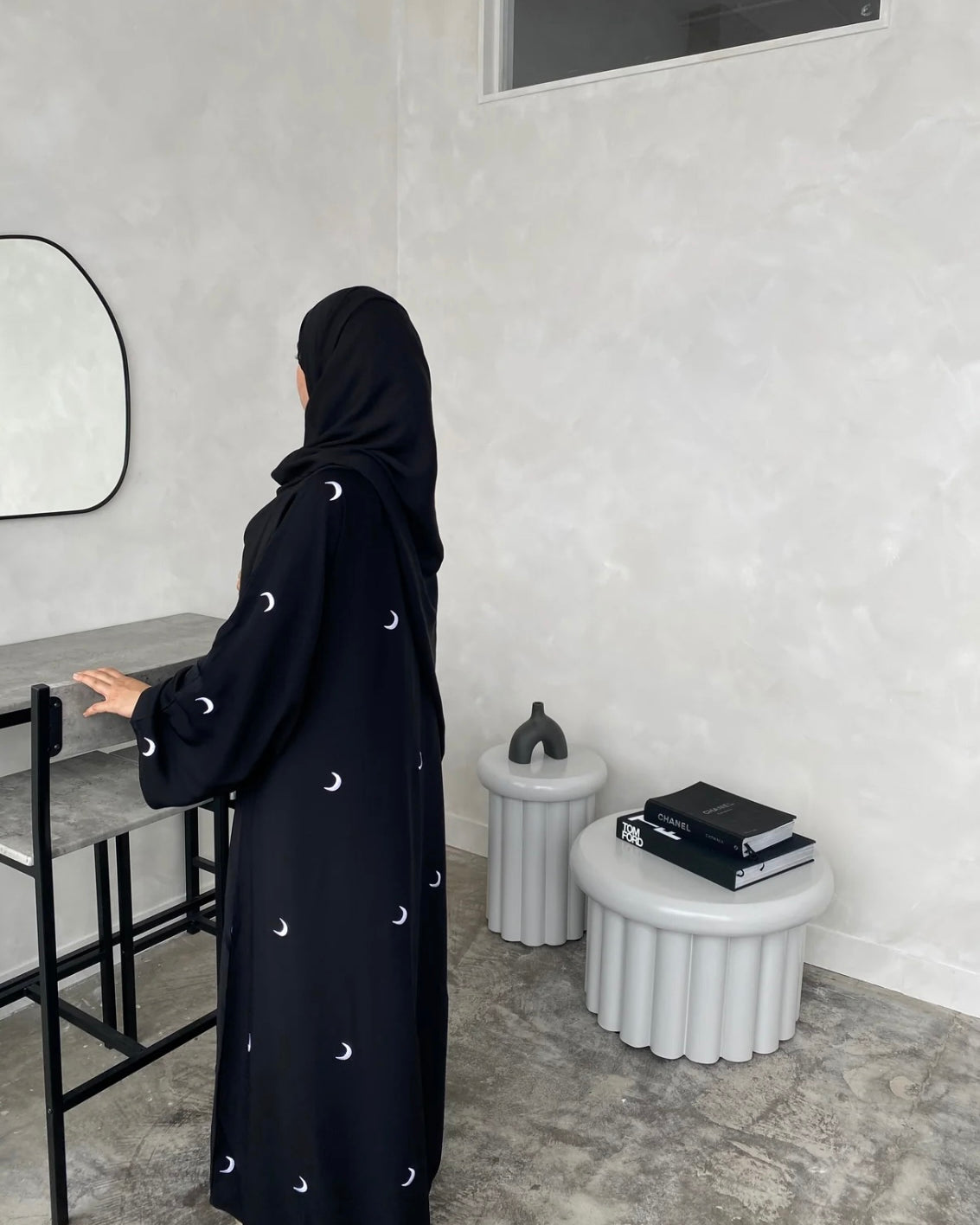 A black abaya with moon patterns