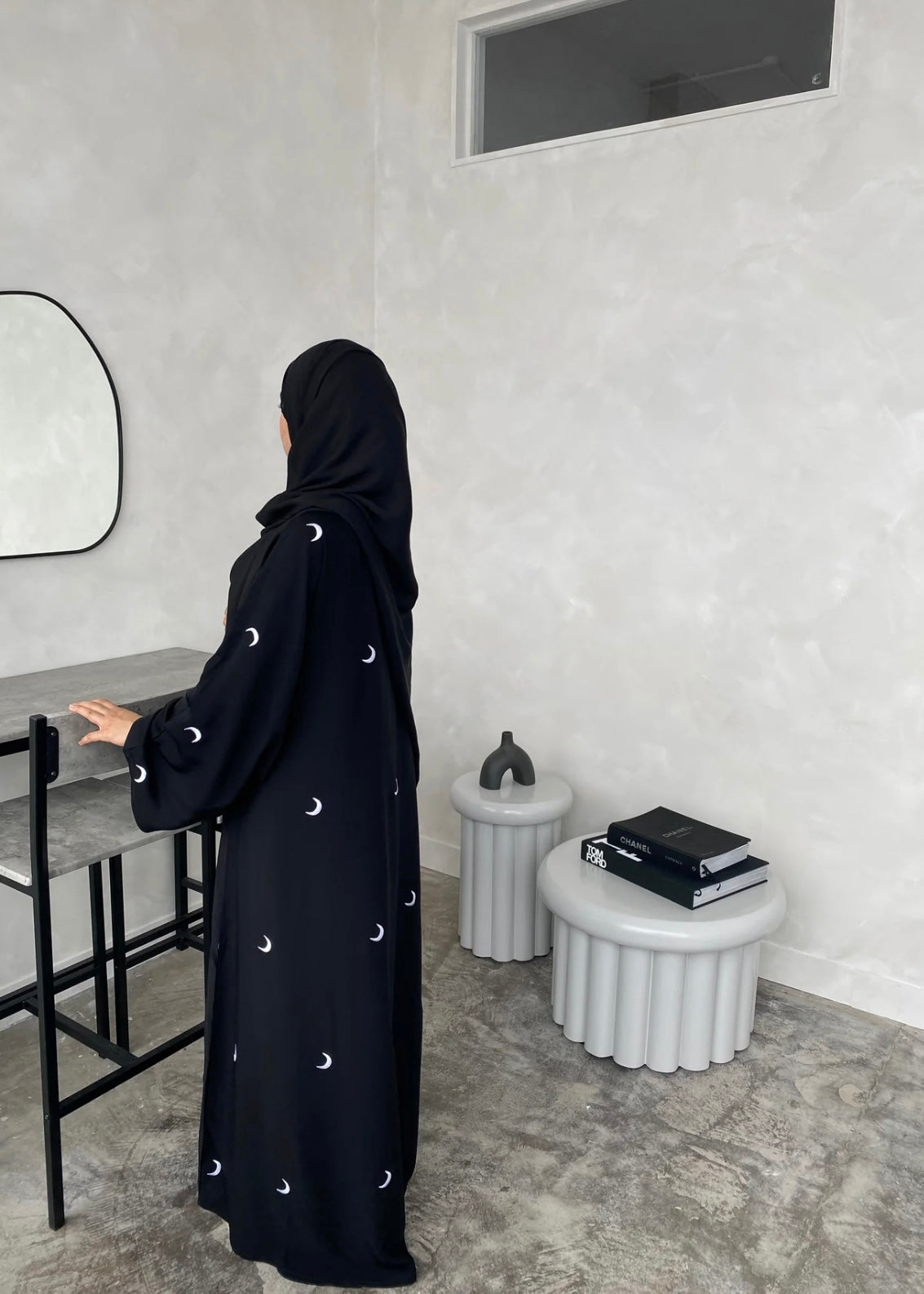 A black abaya with moon patterns